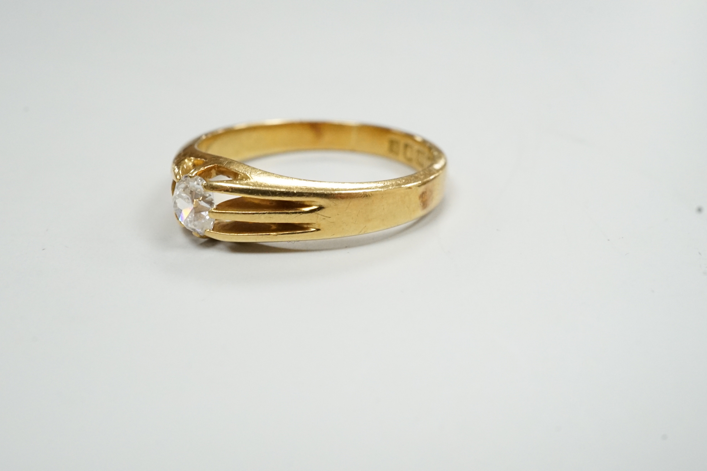 A George V 18ct gold and claw set solitaire diamond ring, size R, gross weight 5.1 grams.